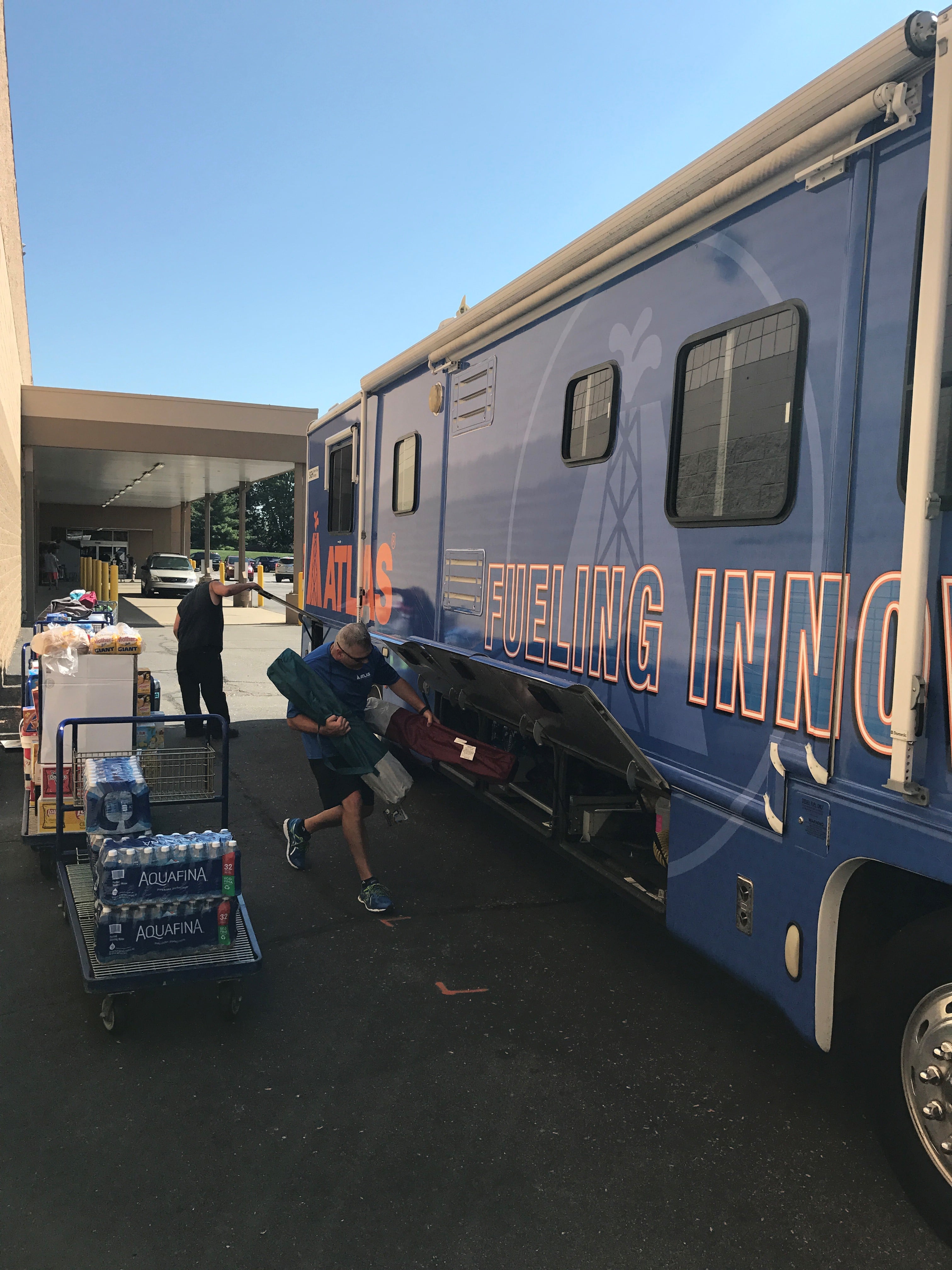 Atlas President Bob Kenyon loads essential supplies into the Atlas Cares RV before it leaves for Puerto Rico